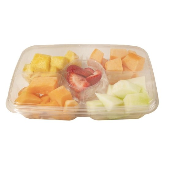 Fresh fruit tray with pineapple, cantaloupe, honeydew, and strawberries in ready-to-serve container for a healthy snack or catering option